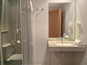 a bathroom with a sink and a shower and a toilet at Apartamentos Vallnord 3000 in Arinsal