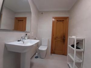 a white bathroom with a sink and a toilet at Arriondas Toyos A in Arriondas +18 photos