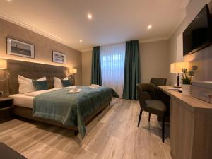 Säng eller sängar i ett rum på Mertinkus Nordseehotel