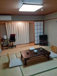 a living room with a table and two chairs at OHTO Ryokan in Kyoto