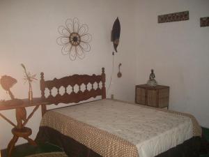 a bedroom with a wooden bed and a wooden table at Casa da Jaca 1 in Itacaré