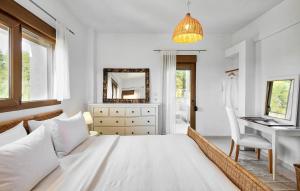 a bedroom with a bed and a desk and a mirror at Sanidiamonds in Sani Beach
