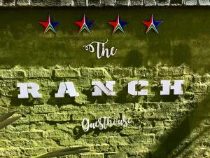 The Ranch Guesthouse في بوتشيفستروم: جدار من الطوب مع الكلمات الطائرة الورقية عليه