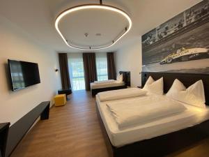 A bed or beds in a room at RINGRAST das Erlebnishotel beim Red Bull Ring