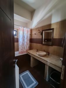 a bathroom with a sink and a mirror at Anemi in Kamilari +20 photos