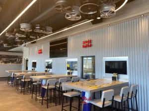a row of tables and chairs in a restaurant at RINGRAST Boxenstopp mit HERZ in Spielberg +24 photos