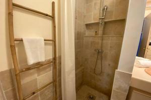 a bathroom with a shower with a glass door at Nice studio with garden and parking - Near beach in Cannes