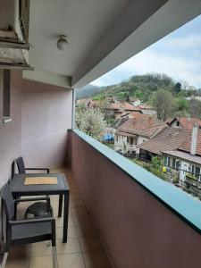 a balcony with a table and a view of a city at Apartman Zivanovic1 in Banja Koviljača