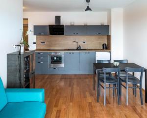 a kitchen and dining room with a table and chairs at Apartment Rustica in Portorož
