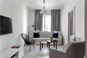 a living room with a couch and a table and chairs at Supreme B2 Apartment in Syntagma in Athens