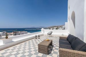 a living room with a couch and a view of the ocean at Josephine Mykonos Town Villa - 1882 in Mýkonos City