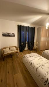 a room with two beds and a couch in it at Appartamento "Roby" in centro Cavalese in Cavalese