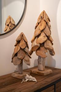 two wooden mushrooms on a table with a mirror at Waldrausch Titisee in Titisee-Neustadt