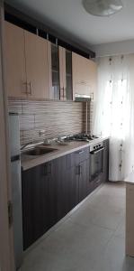 a kitchen with a sink and a stove top oven at CASA LIVIA in Slatina