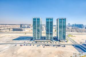 a group of tall buildings in a city at Stylish 2BR in Bella Rose Al Barsha South by Deluxe Holiday Homes in Dubai