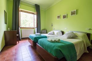 Säng eller sängar i ett rum på Albergo La Genzianella