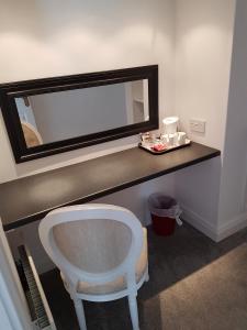 a bathroom with a mirror and a white sink at The Meadows B&B in Moville