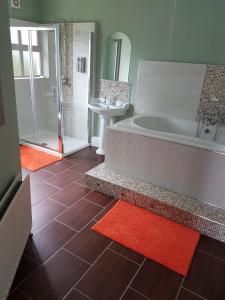 a large bathroom with a tub and a sink at The Meadows B&B in Moville