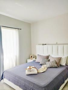a bedroom with a large bed with two bags on it at Emorfia's Apartments in Platanes