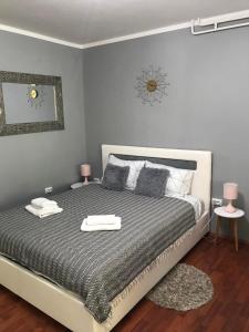 a bedroom with a bed with two towels on it at Apartman studio Pavle i Petra in Sremski Karlovci