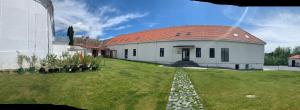 a large white house with a red roof at Pensiunea Salina Gymnasium in Turda