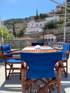 a blue table and chairs on a balcony at Althea Garden House in Hydra