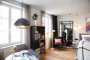a bedroom with a bed and a desk and a table at Livingloft Apartments in Bad Saulgau