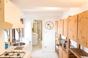 a kitchen with wooden cabinets and a sink at Lion Rooftop Apartments Venice NOVITA' in Venice