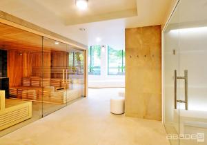 a bathroom with a glass shower and a sink at Apartamenty BalticON Nadmorskie Tarasy in Kołobrzeg