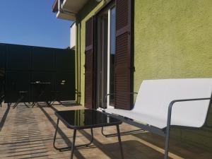 a white bench on a balcony with a table at CASADEI24 in Guidonia