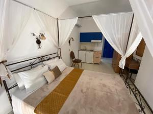 a bedroom with a bed with a spider on the wall at Anastasia Studios, Apartments & Suites in Archangelos