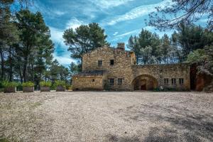 an old stone house with a large yard at Stunning panoramic views and heated pool in Roussillon in Roussillon