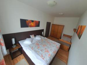 a bedroom with a bed with a floral bedspread at Apartmá na Hané in Kostelec na Hané