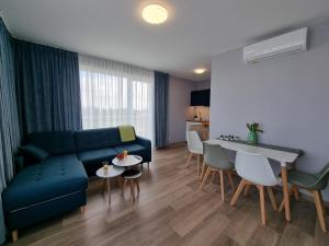 a living room with a couch and a table at Apartament Rodzinny - 365PAM in Gąski