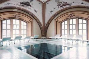 a room with a pool with chairs and windows at T2 Bis, calme, plein centre de Luchon, avec balcon et garage in Luchon