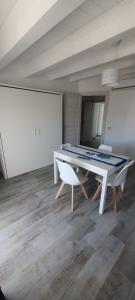 a dining room with a table and two chairs at Amareilmare2 in Marzamemi