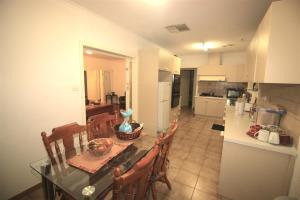 a kitchen and dining room with a table and chairs at Garden Guesthouse - Melbourne Airport Accommodation in Melbourne