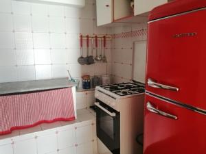 a kitchen with a red refrigerator and a stove at La terrazza sul mare, centro storico di Sperlonga in Sperlonga +22 photos