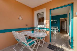 a dining room with a table and chairs at Apartmani Tanja in Martinšćica