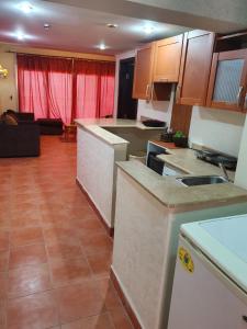 a kitchen with cabinets and a living room at Two-Bedroom Chalet in Pyramids Porto Sokhna in Ain Sokhna