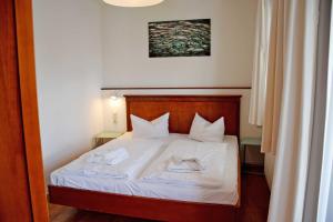 奥斯赛拜-塞林Fewo 20 mit Strandkorb und Balkon的一间卧室配有一张床,上面放着两只猫