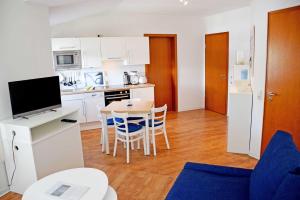 奥斯赛拜-塞林Fewo 20 mit Strandkorb und Balkon的厨房兼餐厅，配有桌椅 更多14张照片