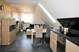 a kitchen with a table and a dining room at Germina Apart in Oberhof