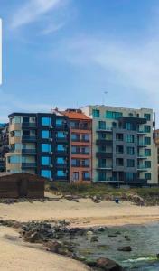 a group of buildings on the beach near the beach at Sunshine Apartment in Pomorie