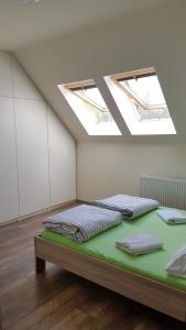 two beds in a room with two skylights at Apartamenty Marynarki Wojennej, Dziwnów in Dziwnów