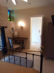 a room with a table and a desk and a door at The Piggeries at La Maison Tumtum Arbre in Loudun +16 photos