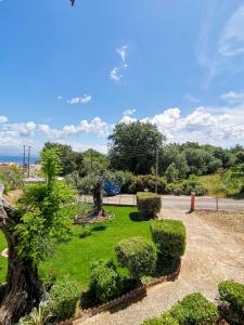 a park with a statue and grass and bushes at Ilias Apartments Dassia By Hotelius in Dassia