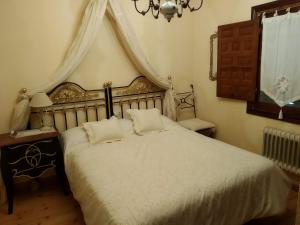 a bedroom with a bed with two pillows on it at El Campillo in Pelabravo +29 photos