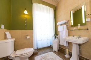 a bathroom with a toilet and a sink and a window at Victoria House Room Only Accommodation in Caernarfon +31 photos