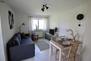 a living room with a blue couch and a table at Ferienwohnung No 15 in Pfullendorf